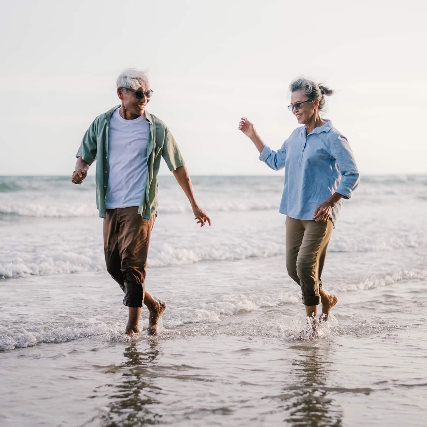 a man and a woman walking on a beach